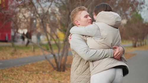 Loving Couple Embracing in Autumn Park