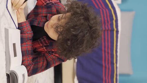 Child Writing in Notebook at Home