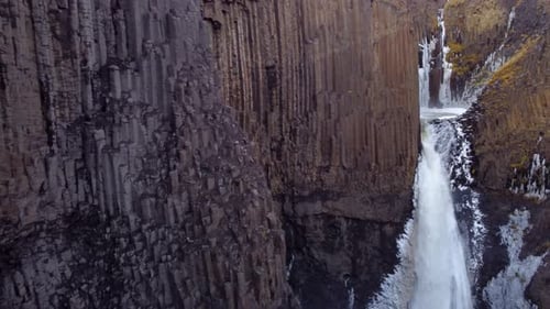 Litlanesfoss waterfall surrounded by basalt columns on the way to taller Hengifoss waterfall, East