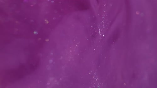 Abstract Background of Sparkling Particles on a Pink Surface
