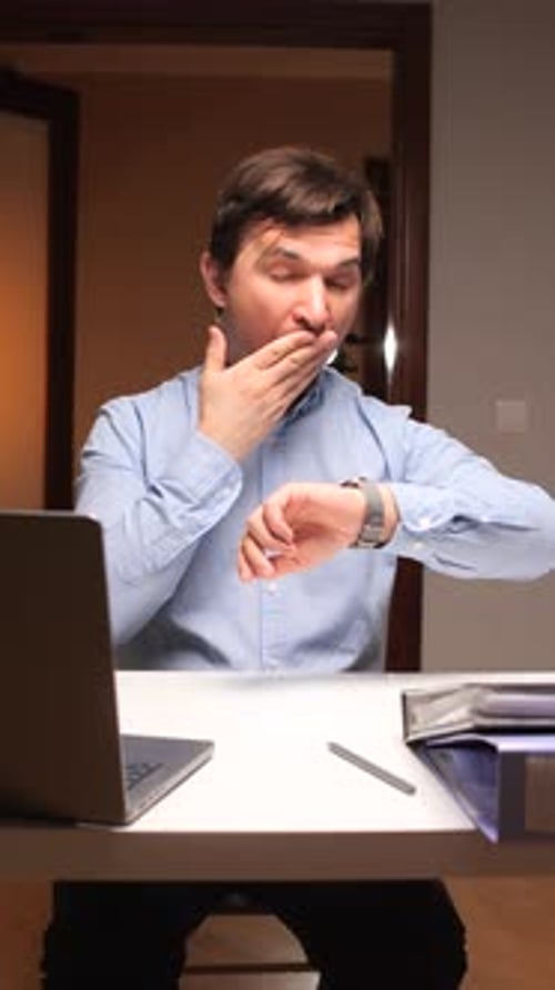 Vertical Video Sleepy Office Worker Yawning and Checking Time at Workplace