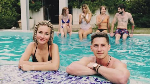 Couple Experience the Vibrant Vibes of a Summer Pool Party Filled with Joyous Moments Among Friends