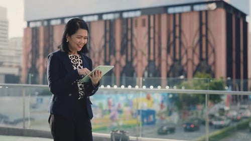 Woman Walking in the City and Using Digital Tablet Using Online Applications Beautiful Older Lady