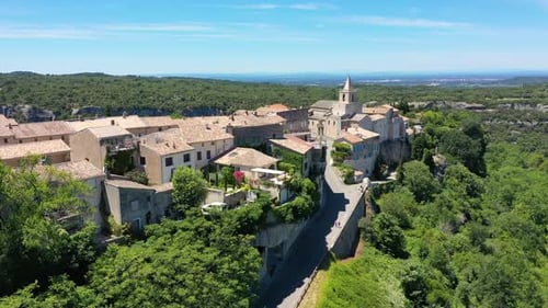 View of Venasque village with old church Notre Dame de Vie to landscape of Luberons, Provence, Franc