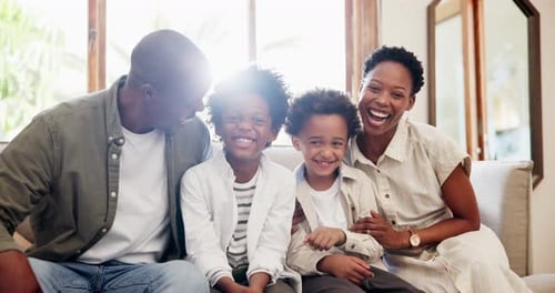 Happy Family Laughing Together Indoors
