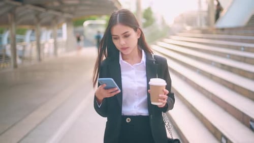 Elegant Woman Using Mobile Phone with Coffee