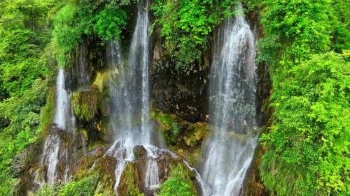 Beautiful waterfall in a tropical forest by aerial view from a drone.