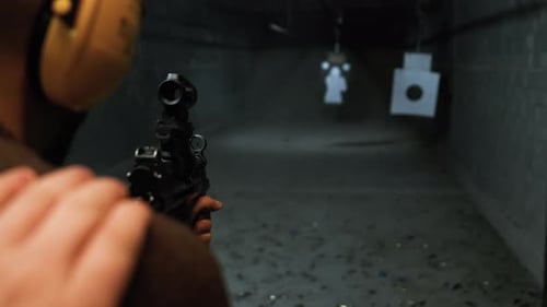 Person Shooting MP5 Gun in Bursts at Shooting Range