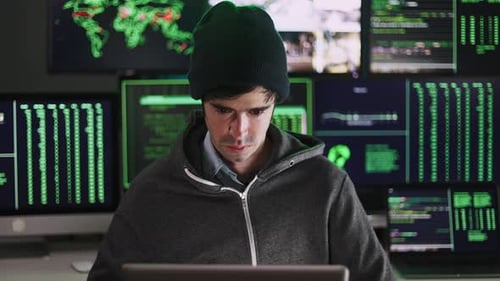 Young Hacker Man Breaking Into Corporate Servers From His Home Office