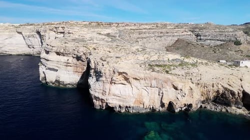 Drone aerial view of the Dwejra cliffs in Gozo, Malta, cinematic 60FPS footage showcasing dramatic
