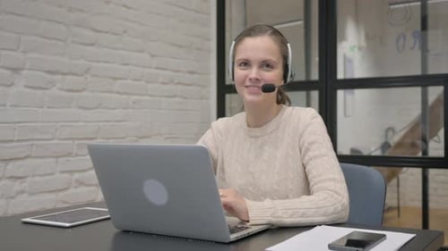 Smiling Woman with Headset in Call Center