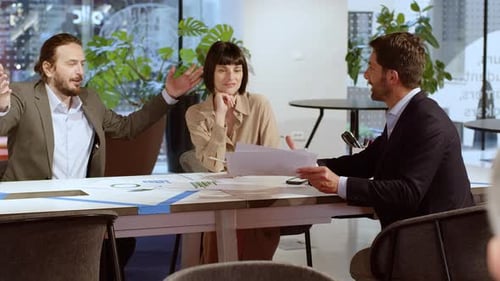 Business Colleagues Discussing Charts in a Modern Office