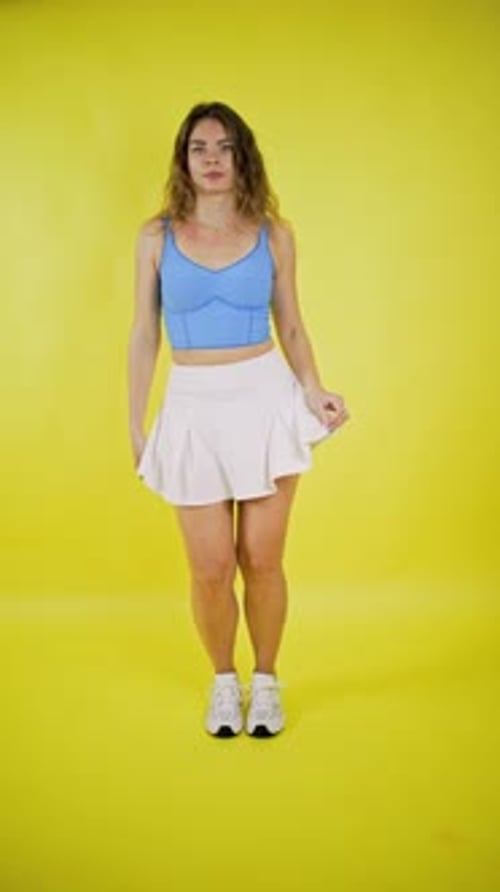 Joyful Young Woman Dancing Energetically in Studio