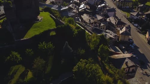 Establishing shot of a village on the italian alps, aerial view on a sunny day