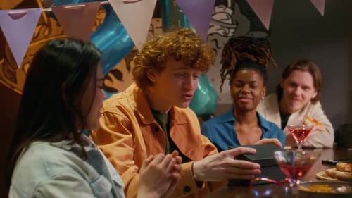 Surprised Birthday Man Hugging and Thanking his Friends for Presents in Bar