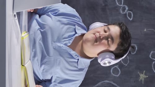 Student Attends Class Online with Headphones