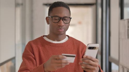 Young Adult Using Smartphone and Credit Card