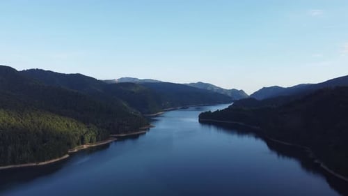 Aerial shot of a river snaking through a mountain valley. Wanderlust and travel