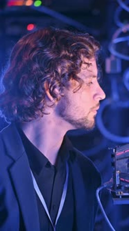 Man analysing servers in a data center. Vertical