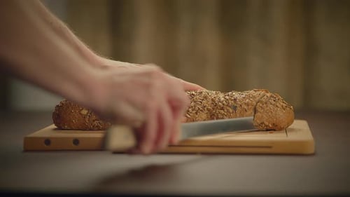 Baguette Sliced on Wooden Cutting Board