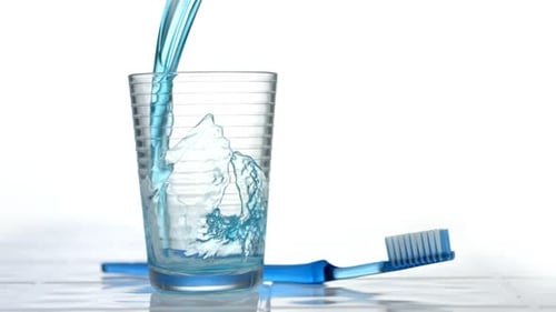 Mouthwash Pouring Into Glass,
