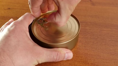 Opening a Golden Can of Food on a Table