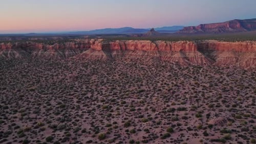 Experience the Breathtaking Aerial View of Stunning Desert Cliffs During a Beautiful Sunset
