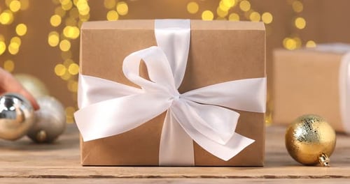Brown Gift Box with White Ribbon and Christmas Ornaments