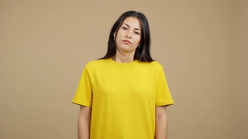 Young Brunette Woman Looking Down in Studio