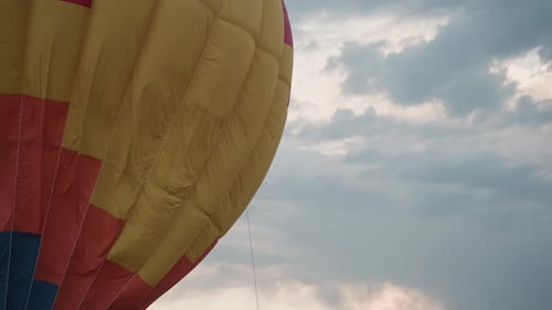 Colorful Hot Air Balloon Against Sky with Clouds