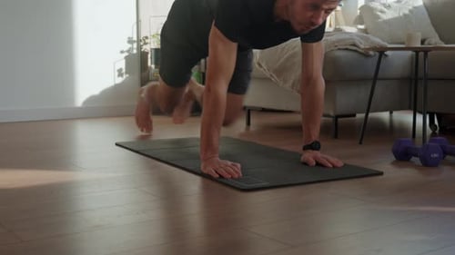 Man Doing Mountain Climber Exercise on Fitness Mat at Home