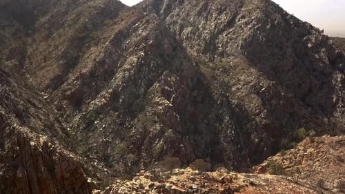 Kings Canyon mountain range, drone descending to show couple on rocky peak