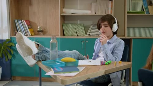 Elementary School Class Children Communicate with the Teacher Answering Question