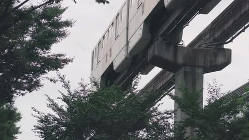 A Monorail Train Passing By In The City Of Tokyo, Japan At Daytime. - low angle - static shot