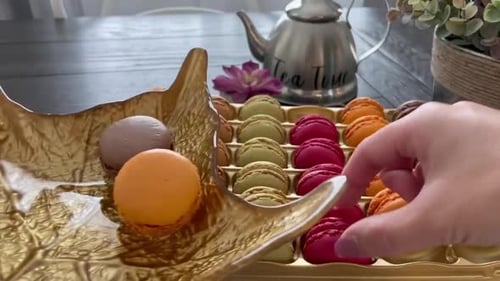 Autumn themed Tea Party with colorful French macarons neatly placed on a festive leaf plate. POV sho