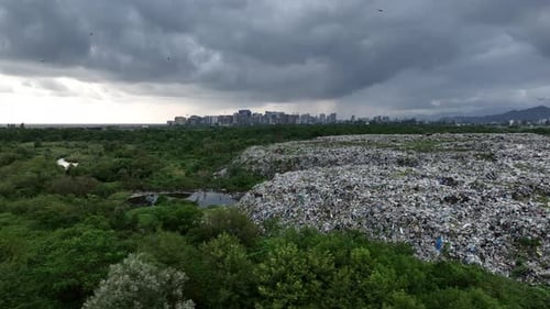 Aerial view of city garbage dump on background of sea. Dump near resort town on seashore in Batumi,