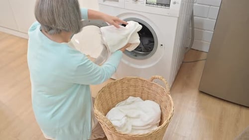 Senior Woman Doing Laundry at Home