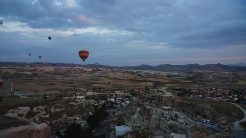Panoramic view of hot air balloons flying over Cappadocia, Turkey, during sunset