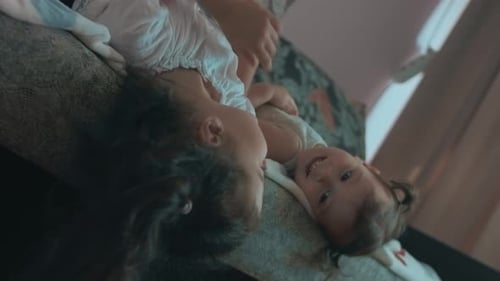 Cute Children Play on Couch Together at Home