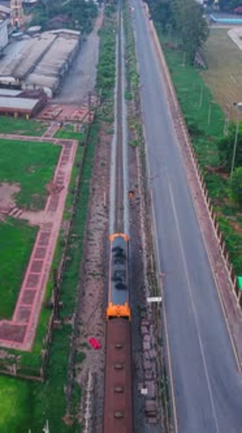 Aerial View of a Freight Train Passing Through the City Center on the Way to Phra Prang Sam Yod
