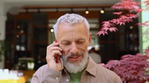 Smiling Man Talking on Phone Outdoors Daytime
