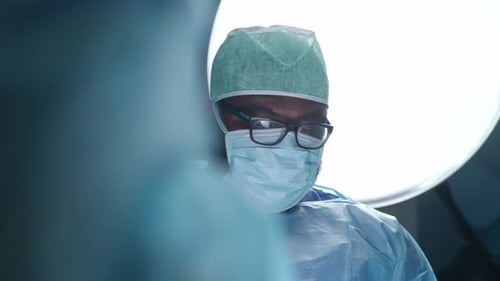 Team of Professional Medical Surgeons Performs the Surgical Operation in a Modern Hospital Doctors