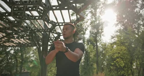 Athlete Stretching Arms Before Workout in Park