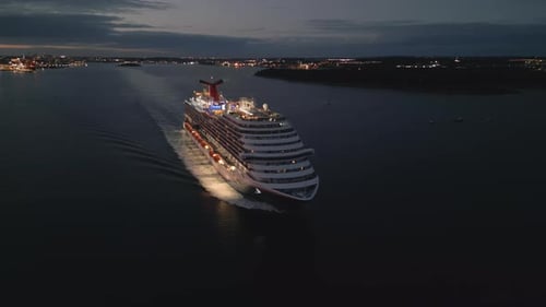 Aerial View of a Luxury Cruise Ship Leaving the Port at Night