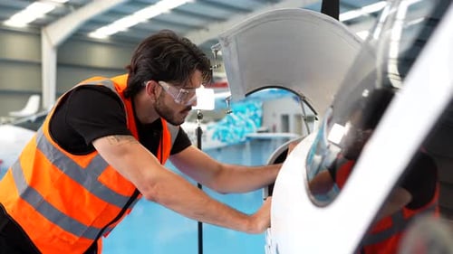 Aviation Engineer Performing Aircraft Maintenance in Hangar