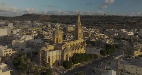 Aerial view of church and town at sunset, Gozo, Malta.