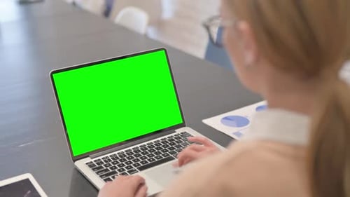 Woman Using Laptop with Green Screen