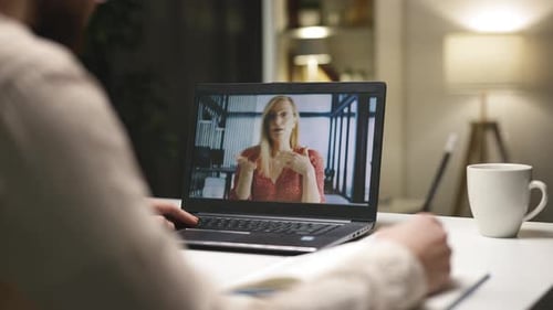 Person Having Video Call and Taking Notes