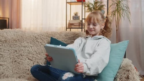 Girl Draws on Tablet in Living Room