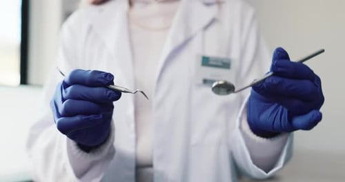 Dentist, hands and equipment in office, uniform and dental probe for surgery in hospital